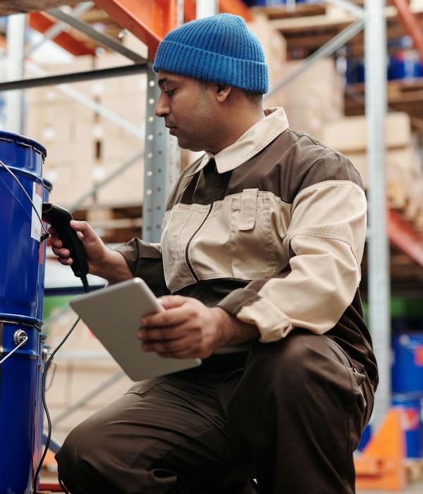 High-tech warehouse with robotic arms handling inventory and digital management displays